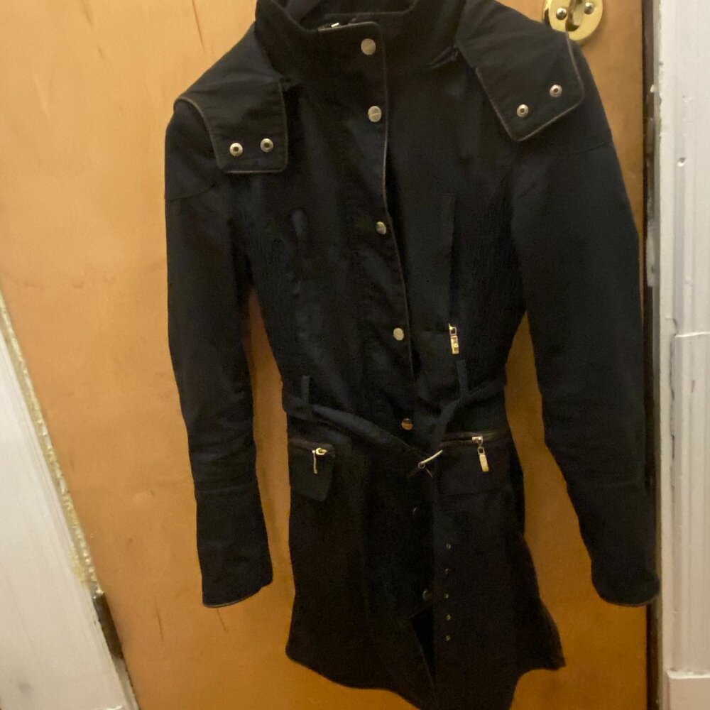 Parisian chic black trench coat with gold zipper accents and a belted waist